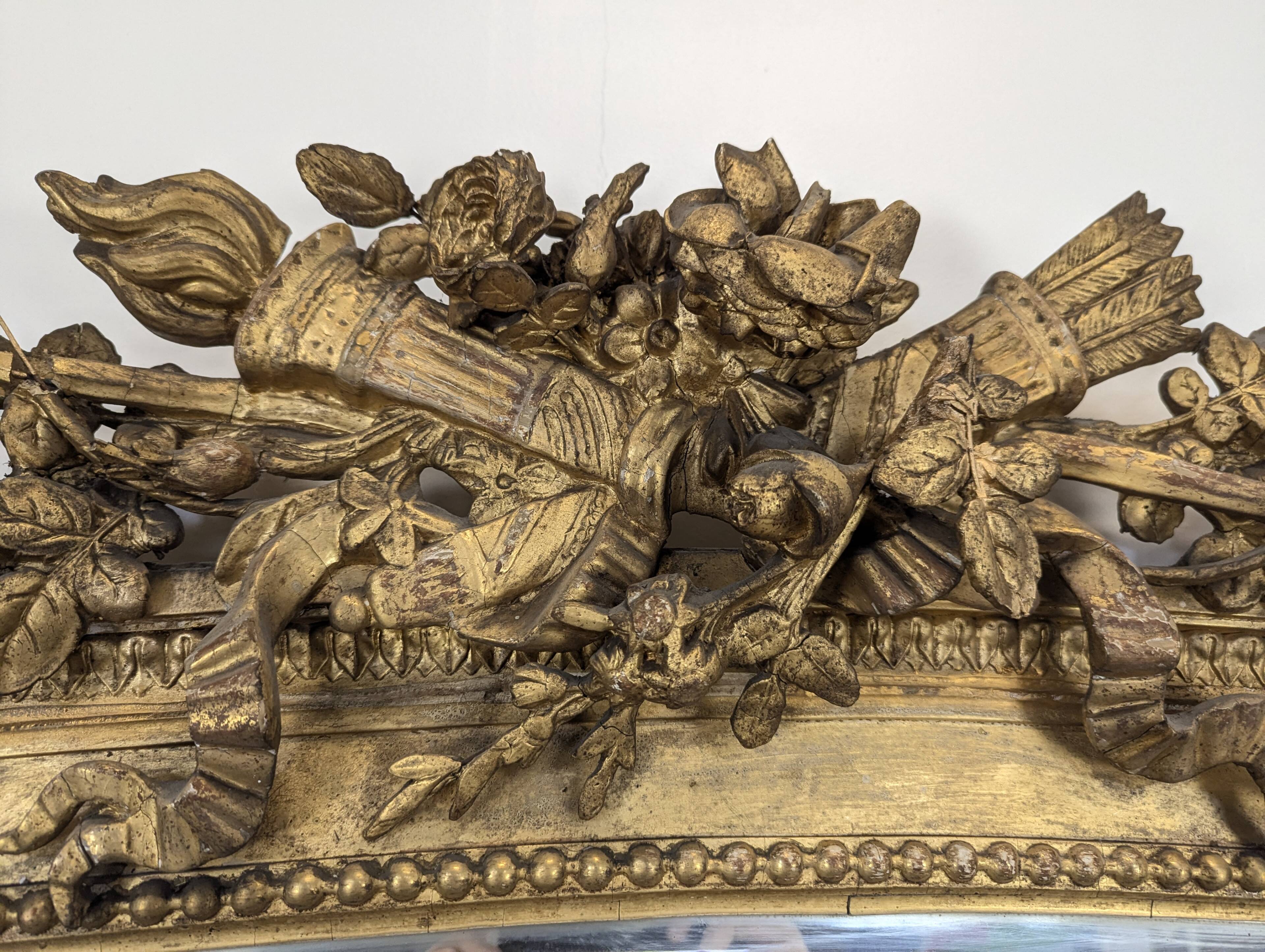 Large gilded wooden mirror in Louis XVI style from the late 19th century.