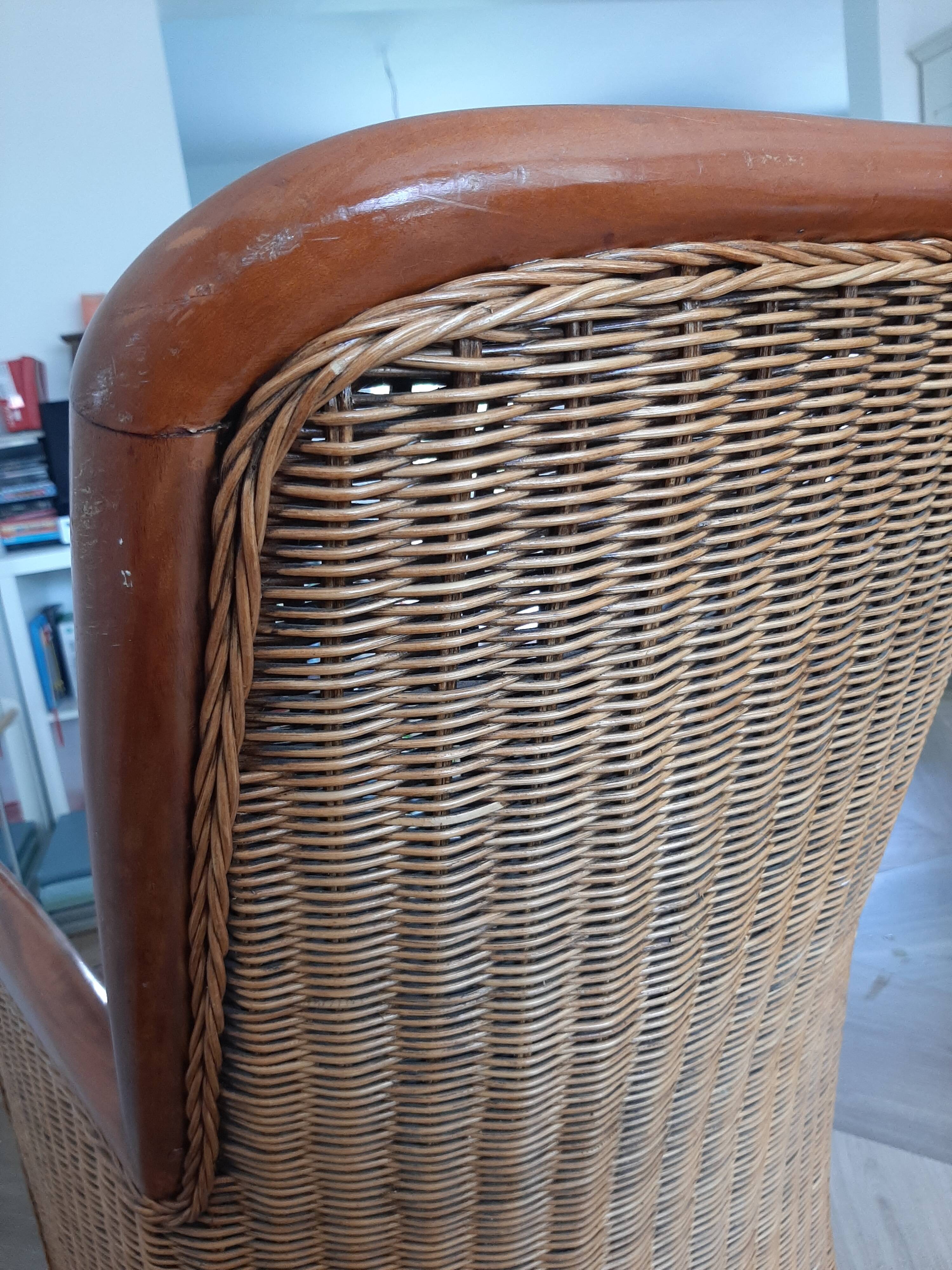 Armchair in woven rattan and exotic wood