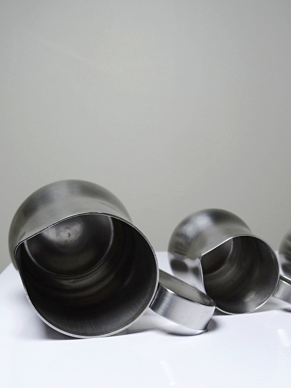 Set of 4 vintage bar measures in brushed stainless steel from the 60s-70s.