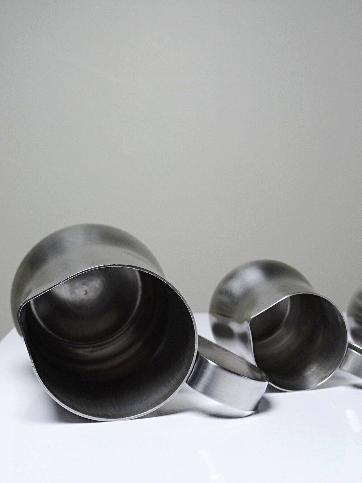 Set of 4 vintage bar measures in brushed stainless steel from the 60s-70s.