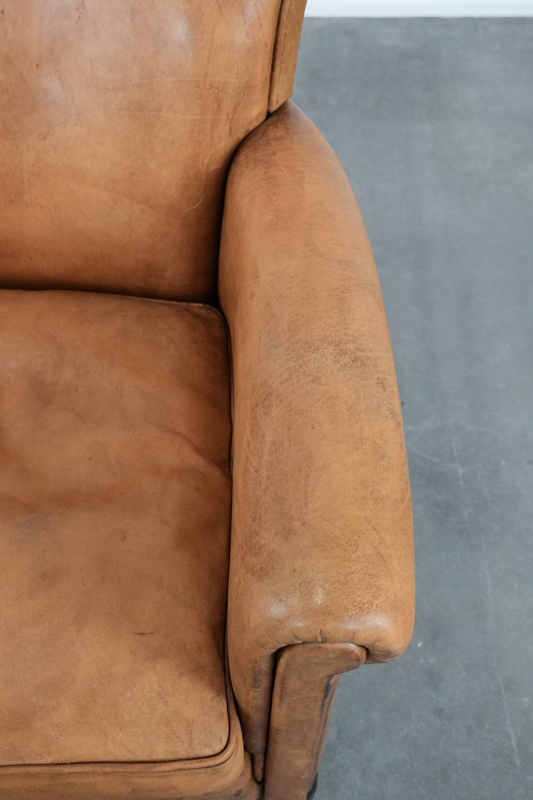 Beautiful subtle vintage sheepskin armchair with elegant legs