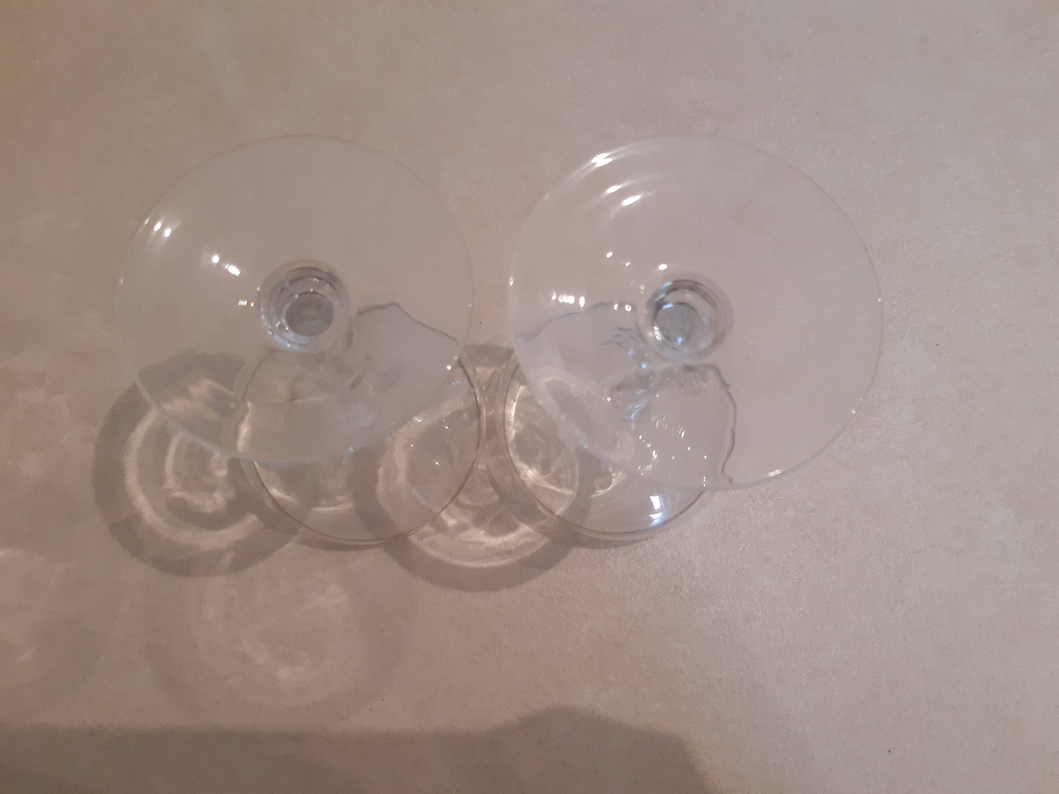 Two small crystal champagne glasses with twisted stems.