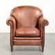 Comfortable vintage sheepskin armchair finished with decorative nails