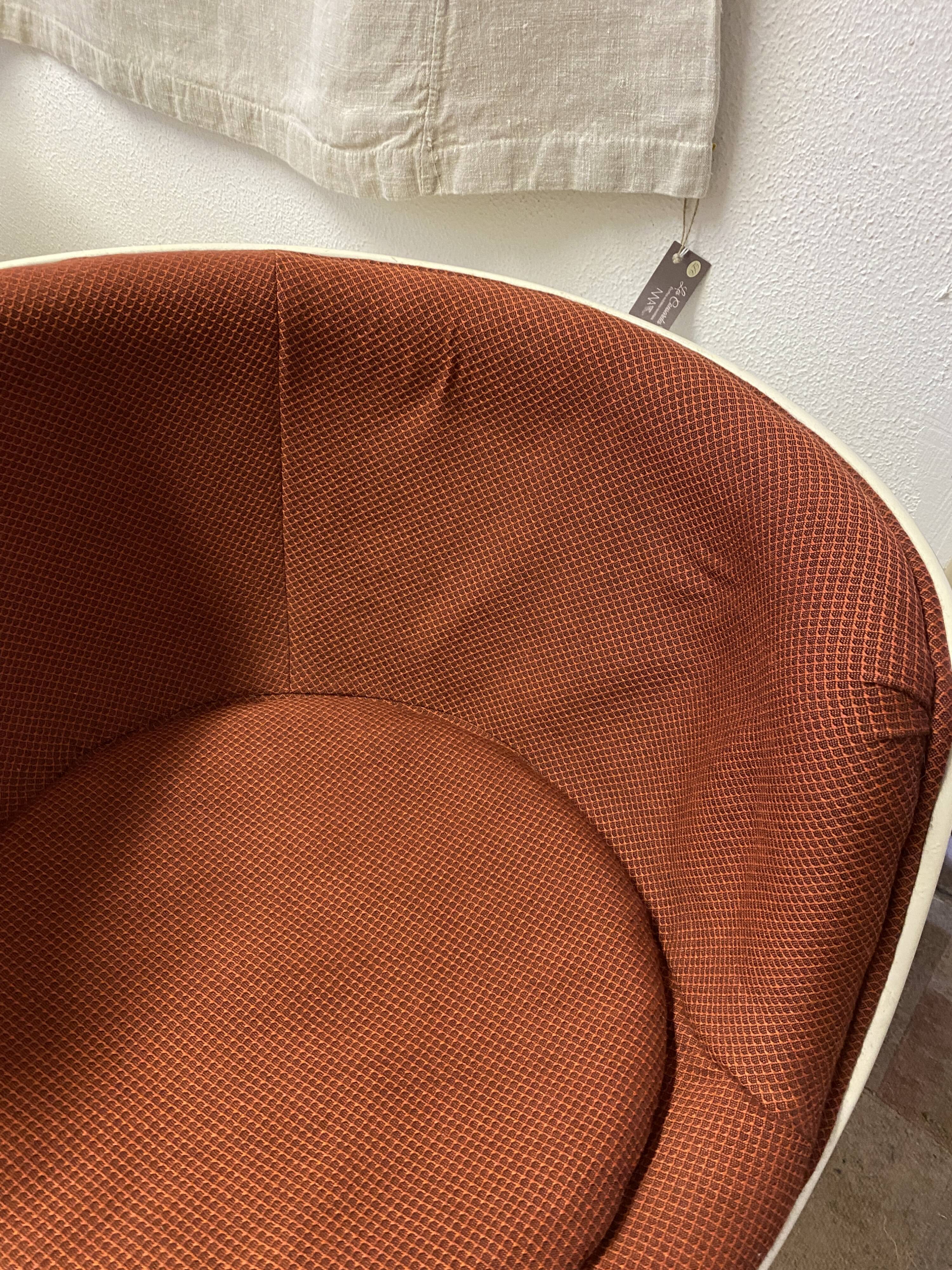 Two cognac-colored swivel chairs made of fiberglass from the 1970s