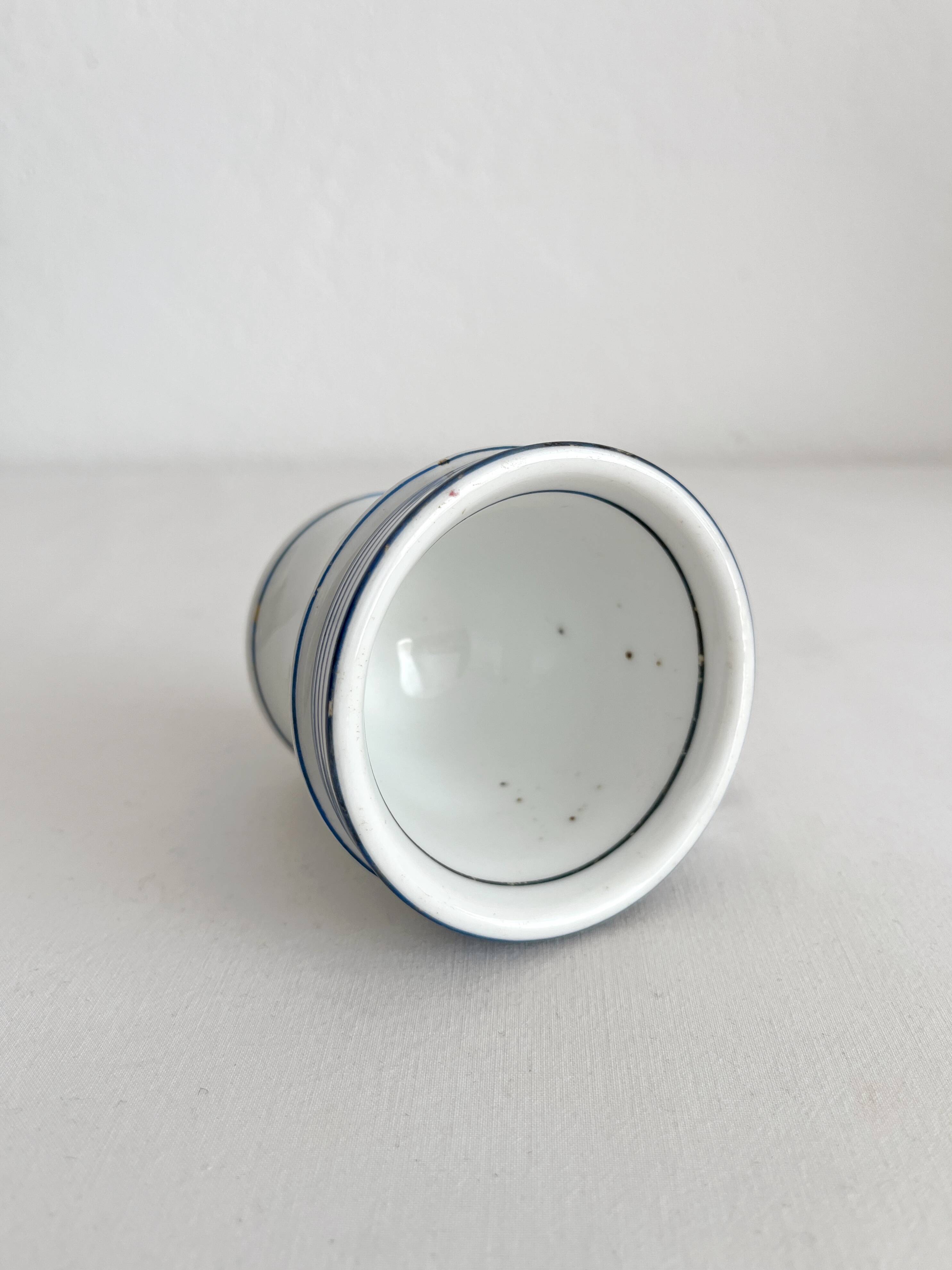 Antique porcelain teacup with blue rims, 19th century