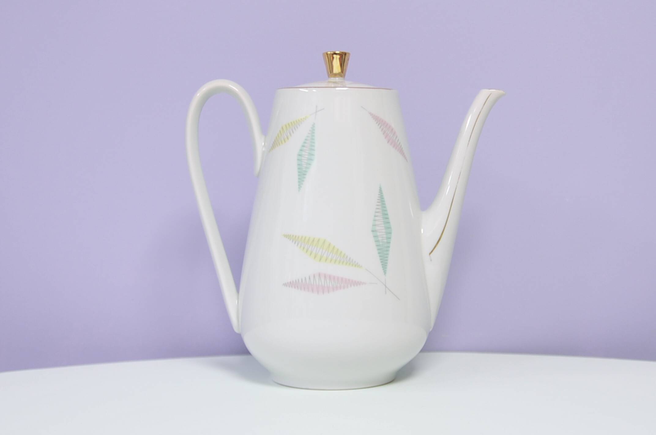 White teapot with pastel flowers