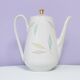 White teapot with pastel flowers