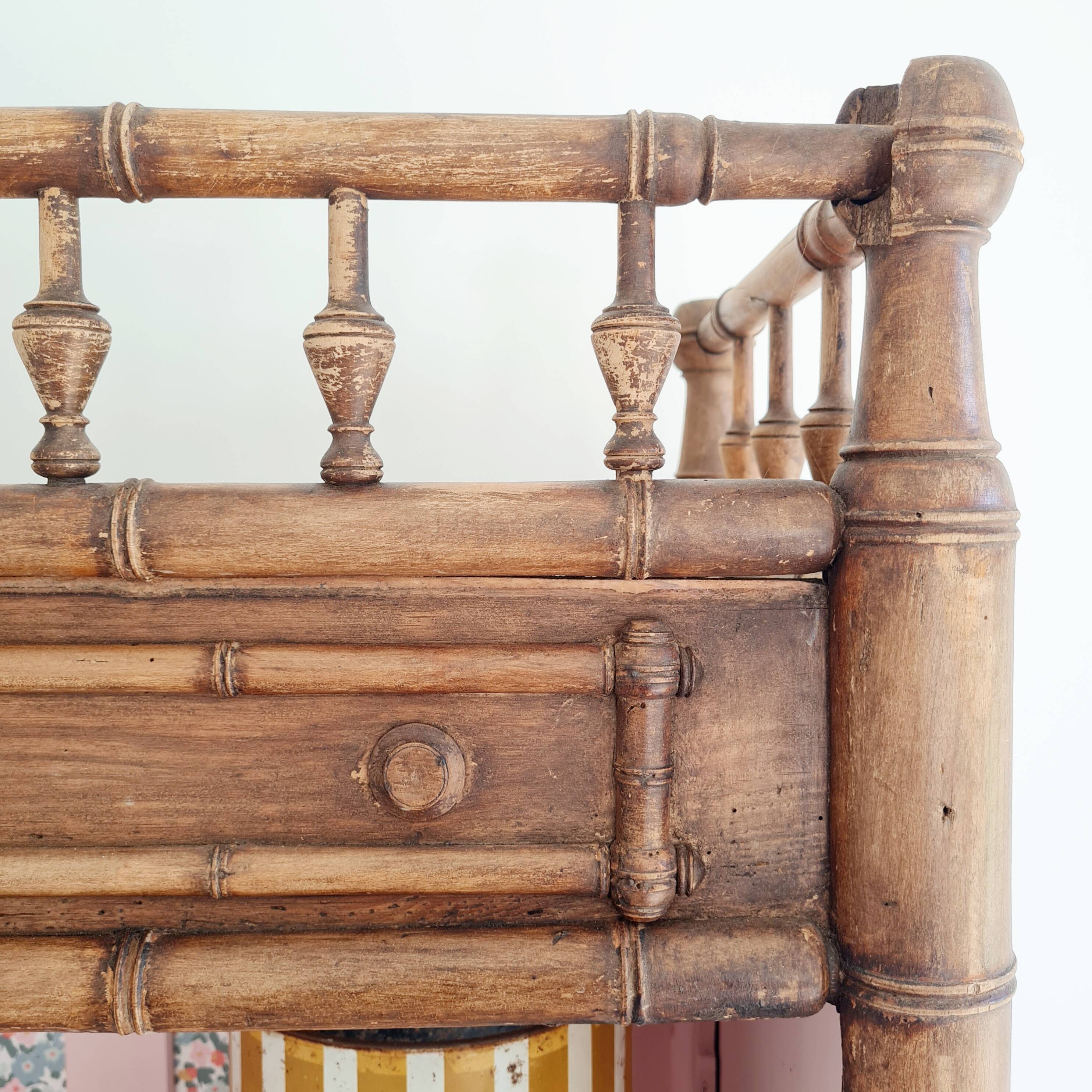 Library, old wooden cabinet imitating bamboo painted in pink