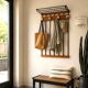 Wall-mounted coat rack in wood and black.