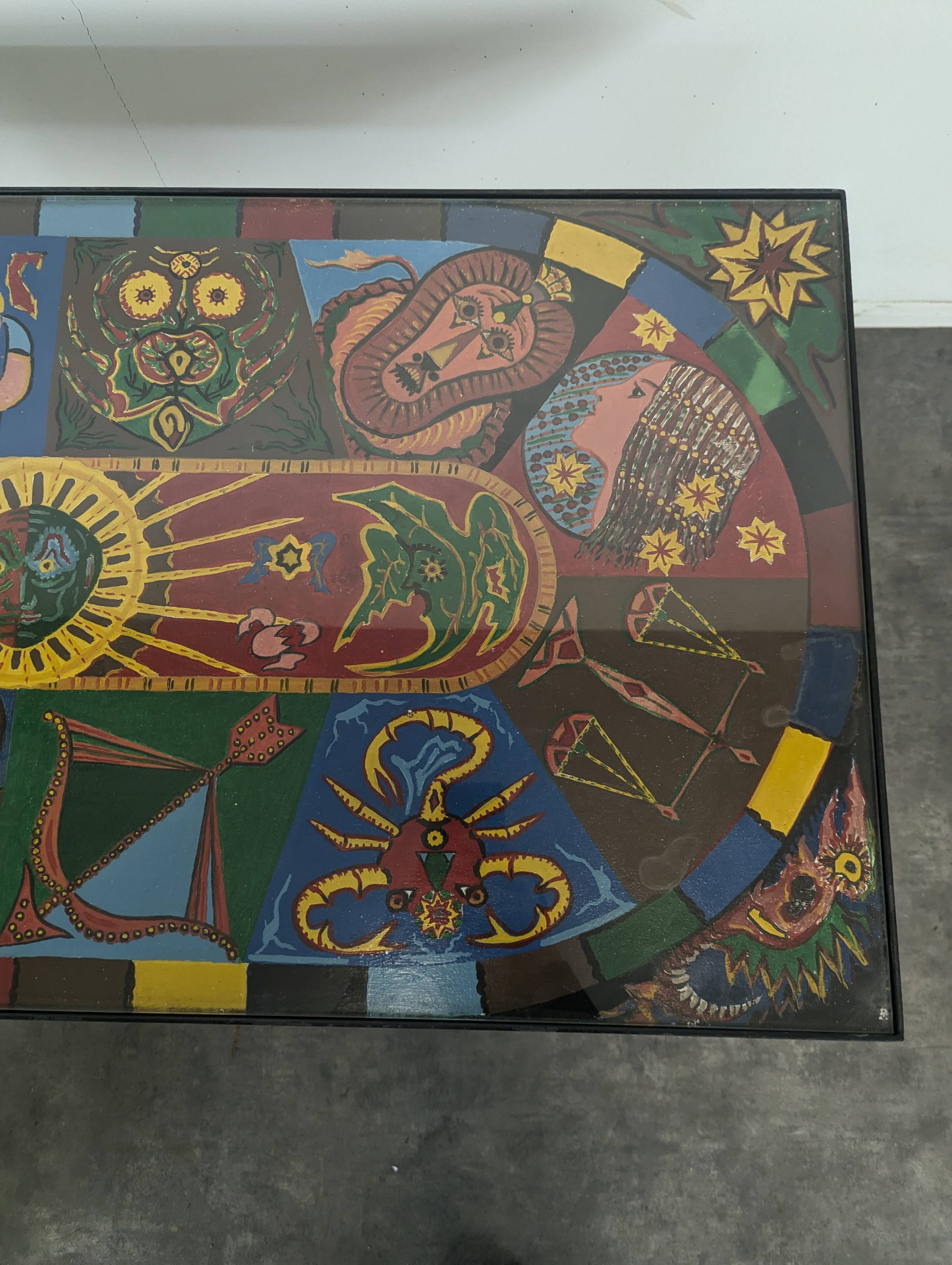 Chrome steel coffee table with zodiac signs decoration.