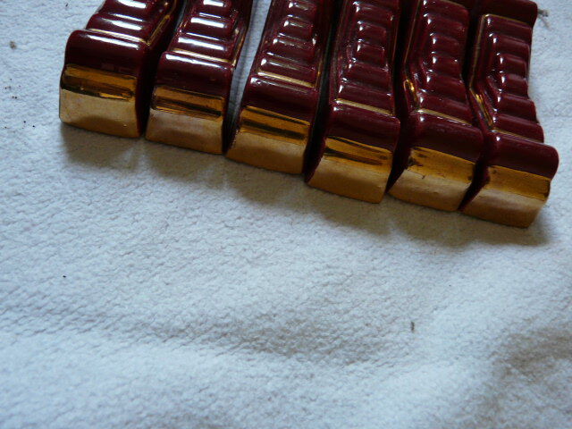 together 12 carries knives and a red enamelled earthenware bottle