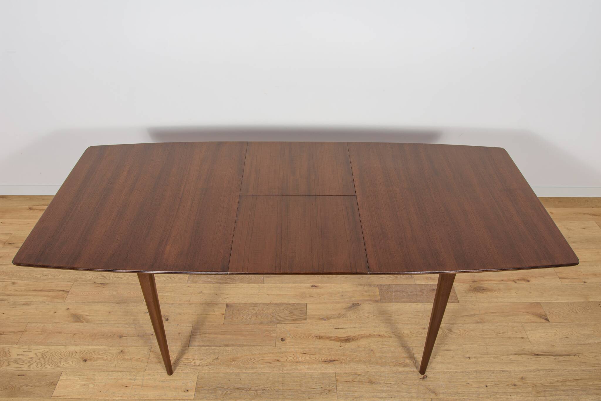 Extendable teak dining table in Mid-Century style from McIntosh, UK.