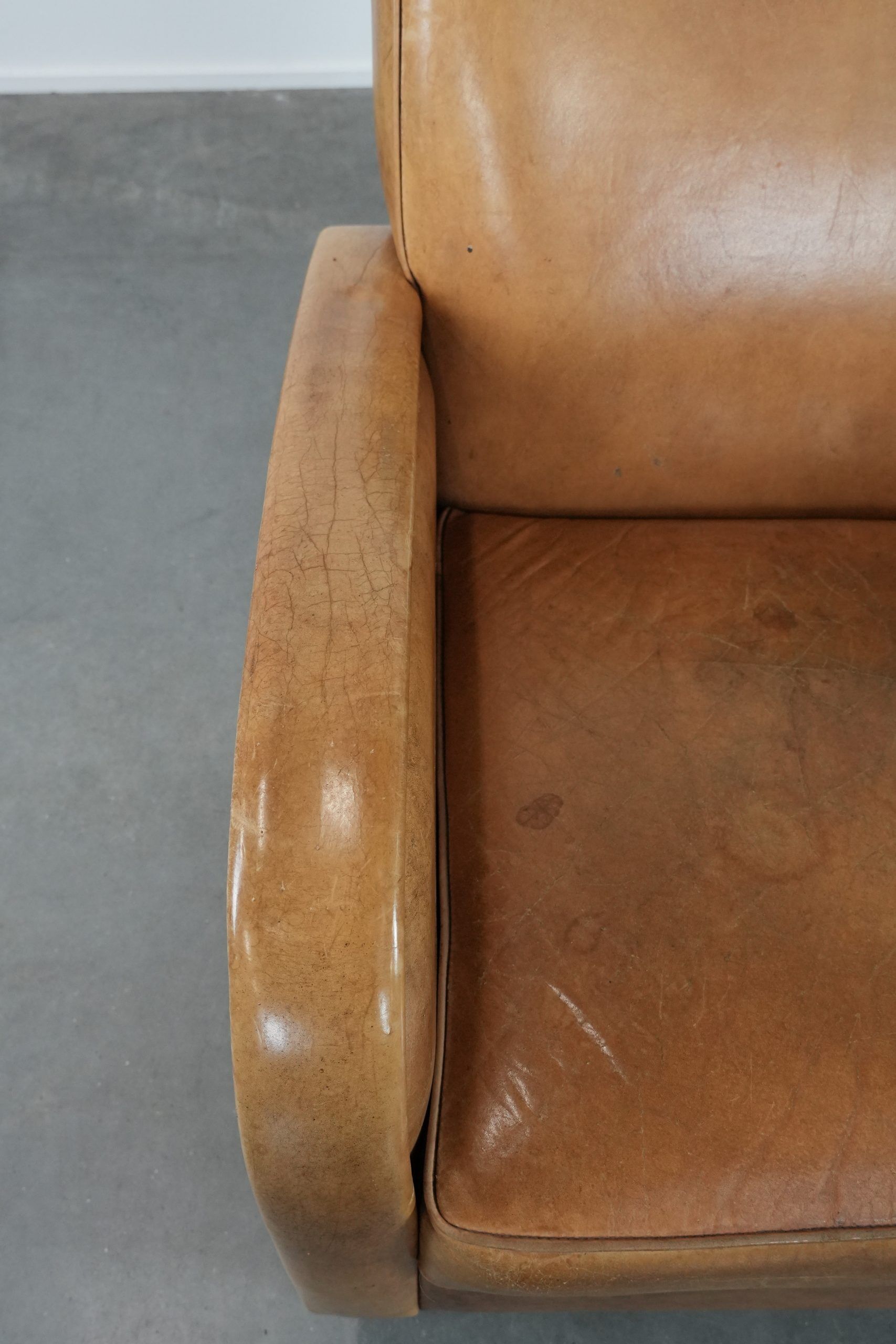 Luxury armchair made of cowhide leather with a beautiful warm colour scheme