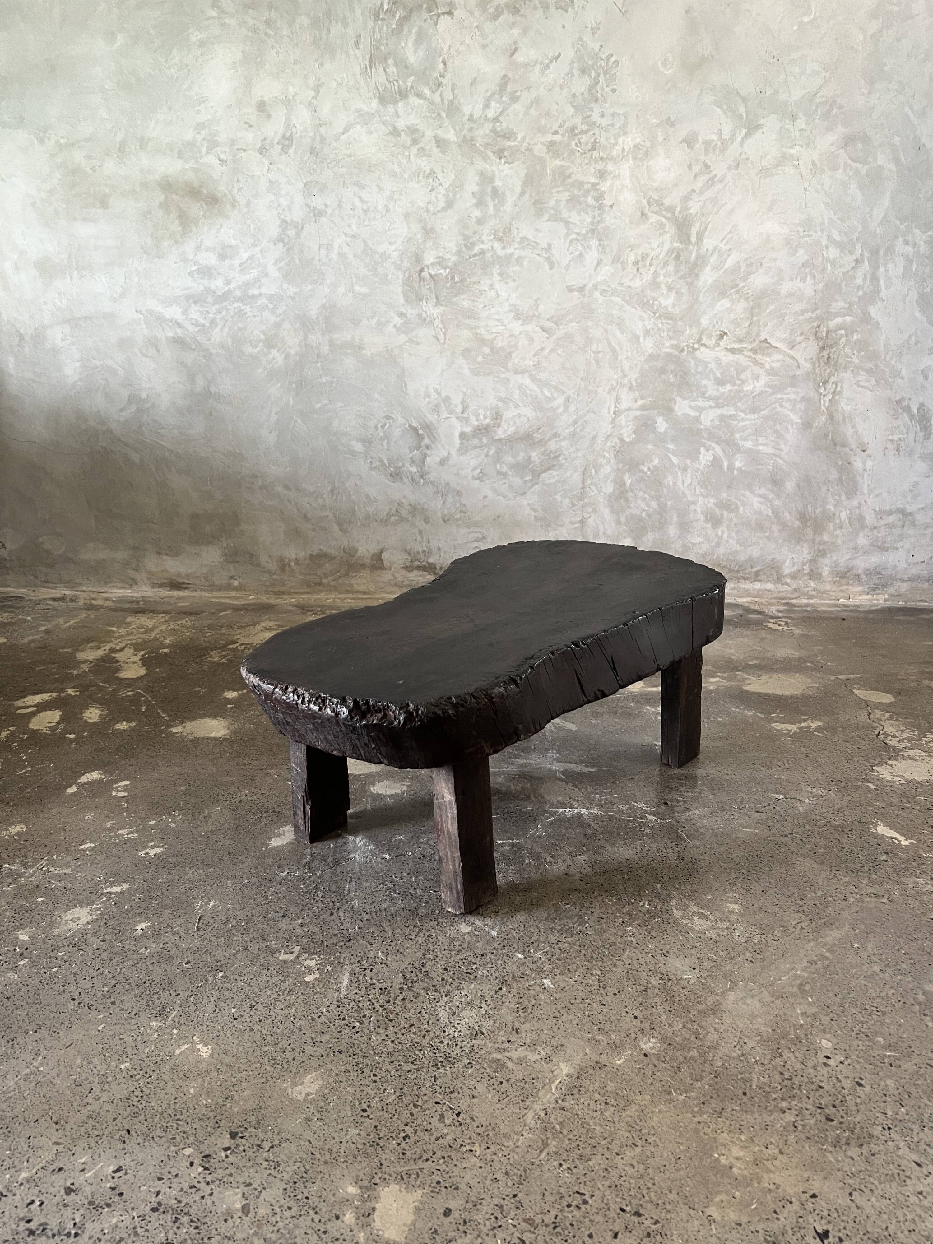 Small old Asian wooden coffee table in Japanese style, kidney-shaped top