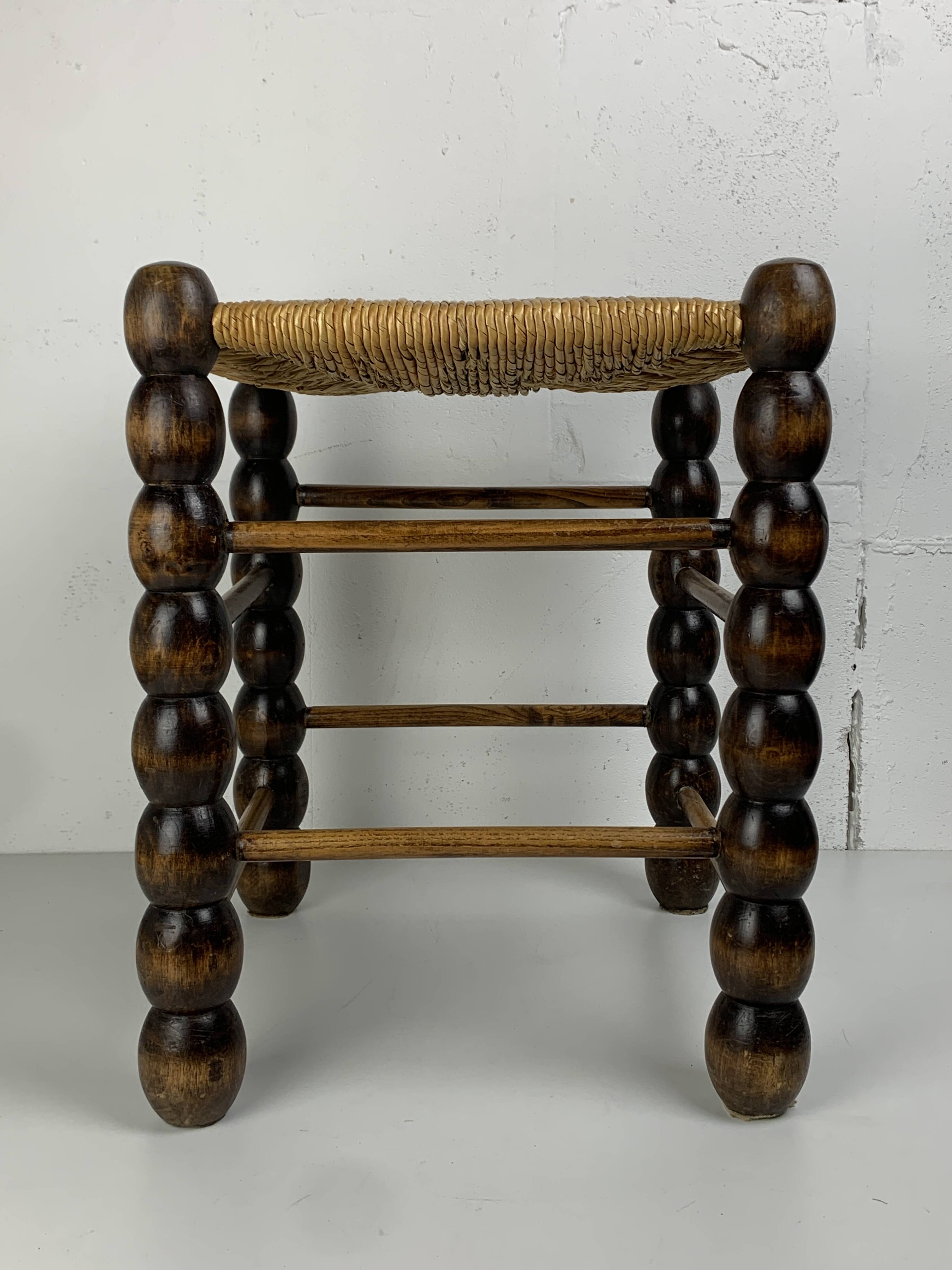 Brutalist wood turned bobbin rush stool in the style of Charles Dudouyt