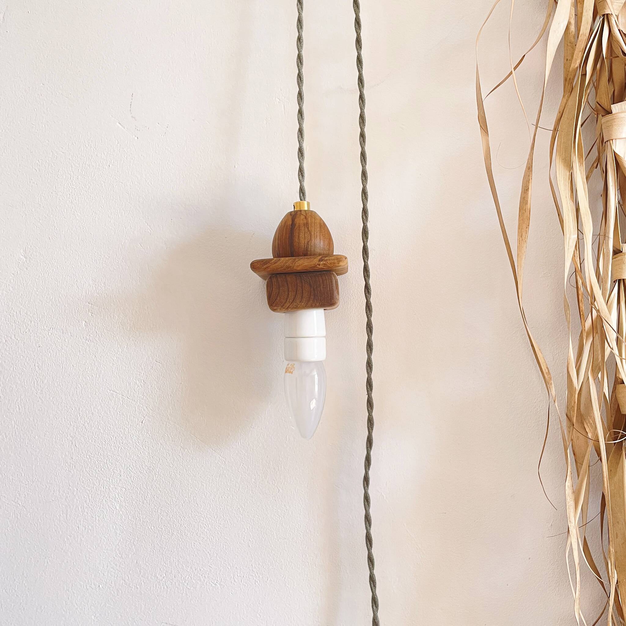 Wooden portable lamp with green cable