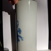 White porcelain vase from Limoges with blue decoration and gold rim.
