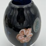 Double-lined blown glass vase with flower inclusions.