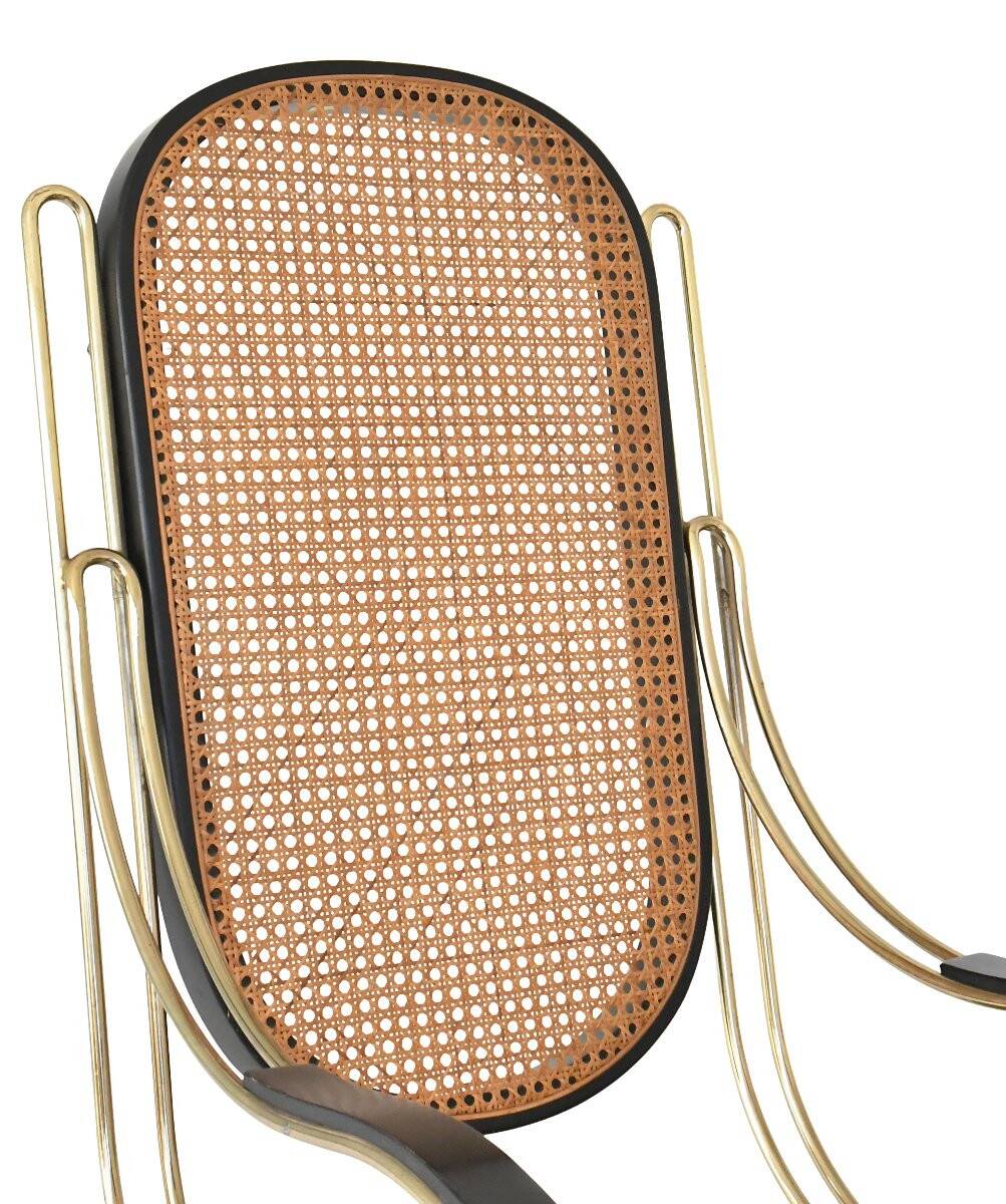 Modernist rocking chair in gilded brass and cane.