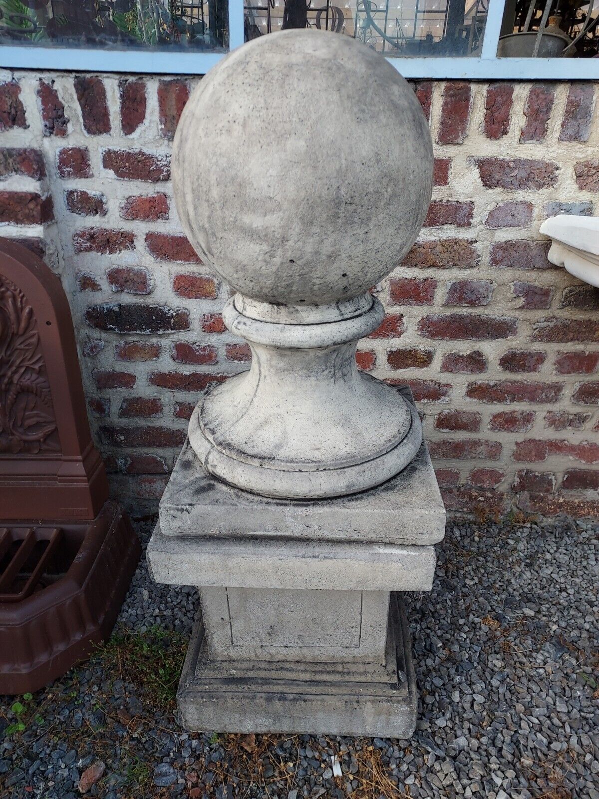 Ball on base in gray patinated reconstituted stone