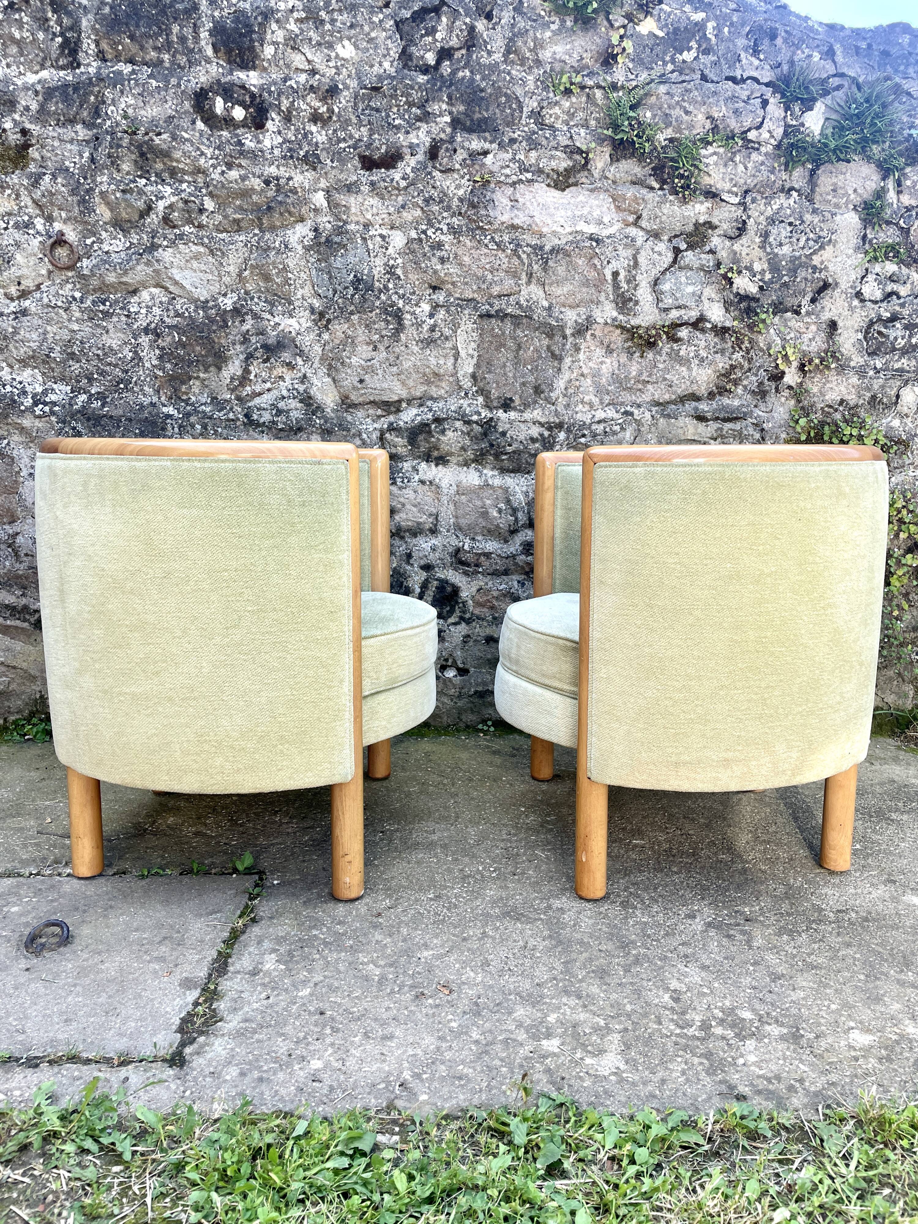 Pair of barrel-shaped armchairs in beech and almond green velvet by Maison Rosello
