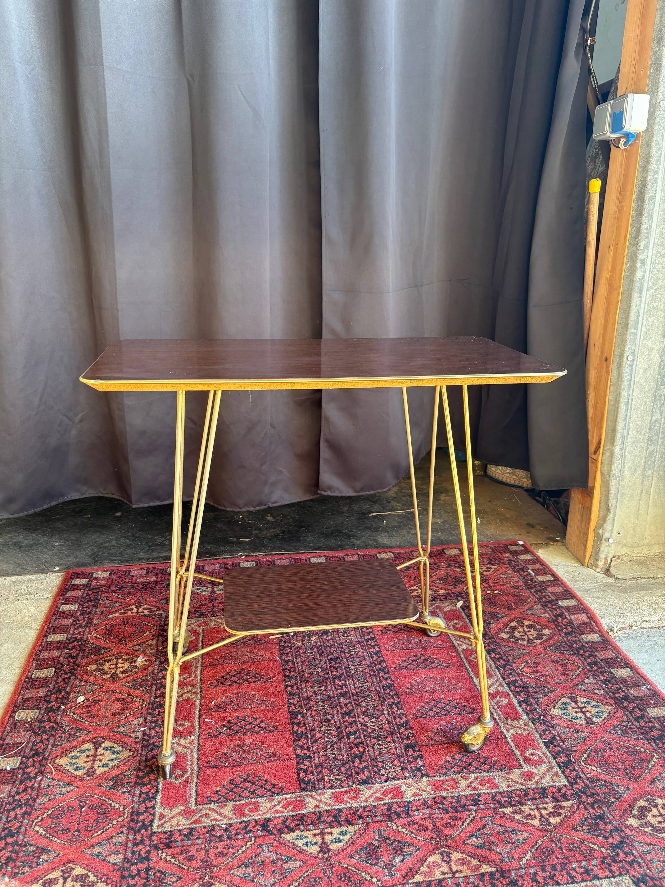 Vintage 1960s rolling dessert trolley in gold metal and formica.