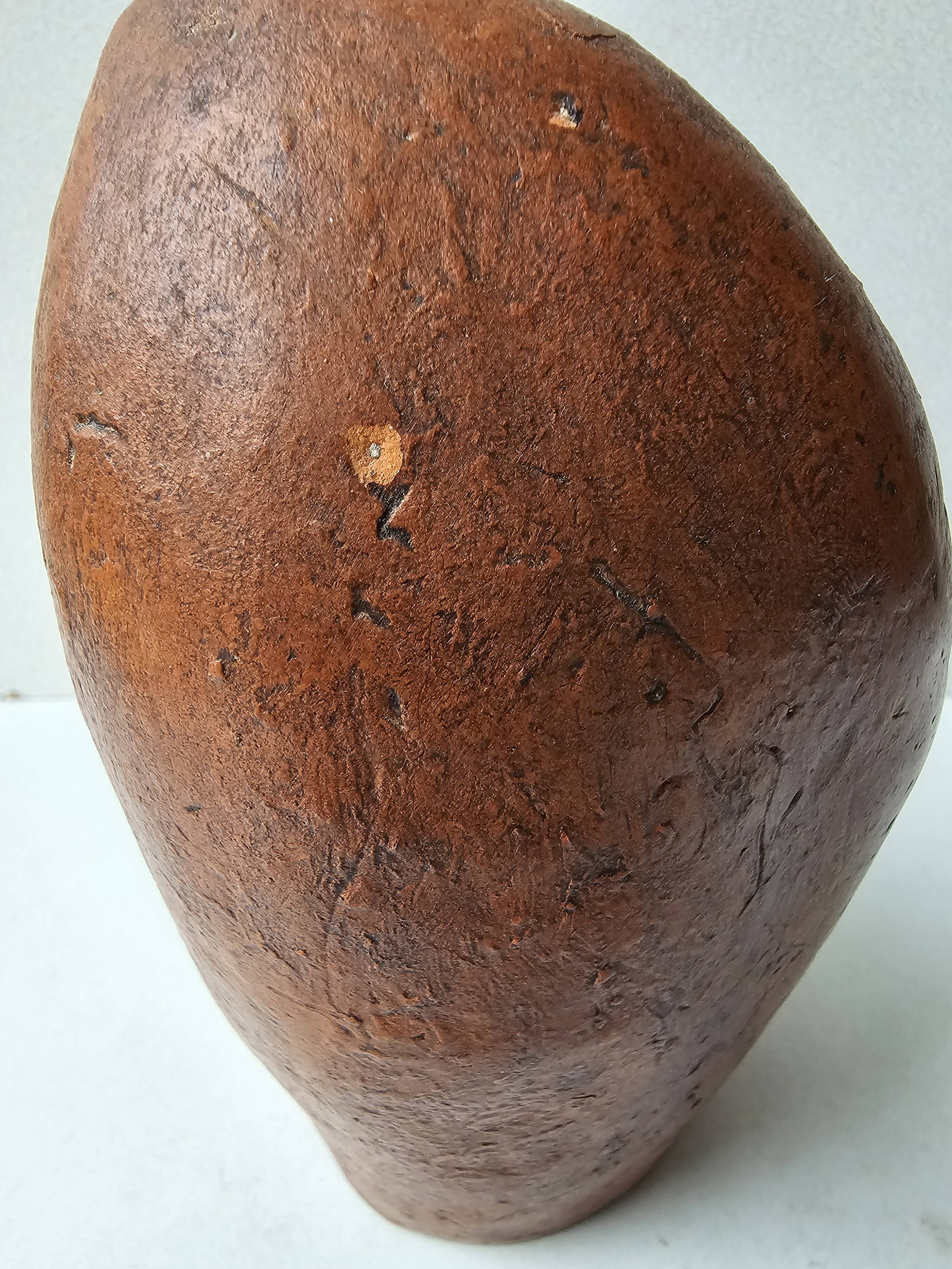 Terracotta face sculpture in African art style