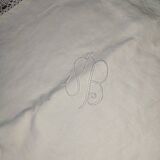 Ancient monogrammed pillowcase adorned with cotton lace