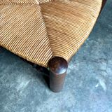 Brutalist low chair in dark wood and straw no. 1