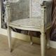 Gondola armchair in Louis XVI style, carved wood with a cream patina.