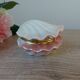 Vintage shell-shaped catchall in iridescent cream and pink ceramic.