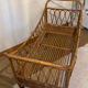 Vintage rattan baby cot on wheels.