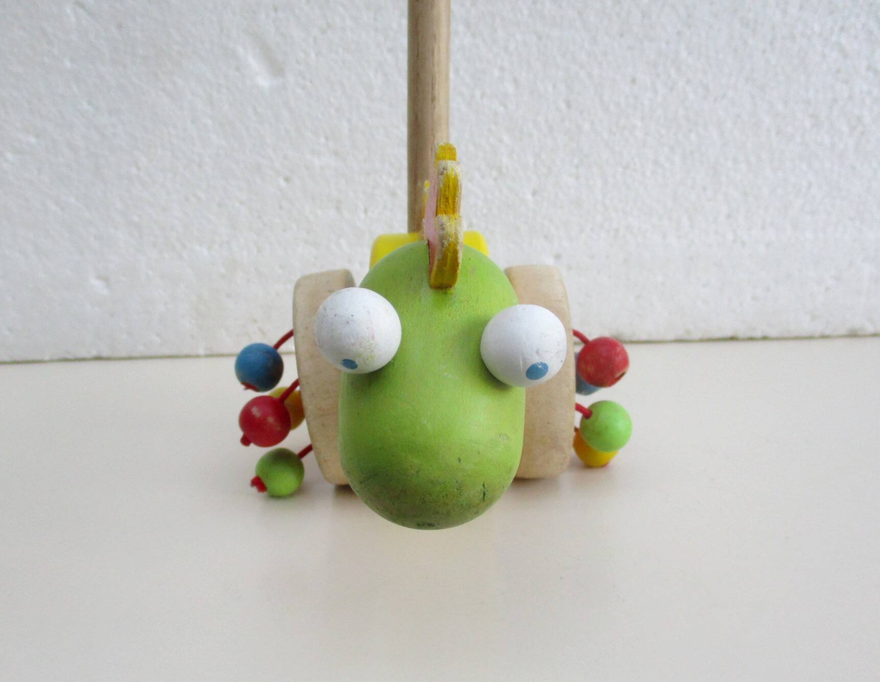 Push toy, wooden dinosaur. Brand: Bino