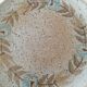 Speckled stoneware plate with floral decoration