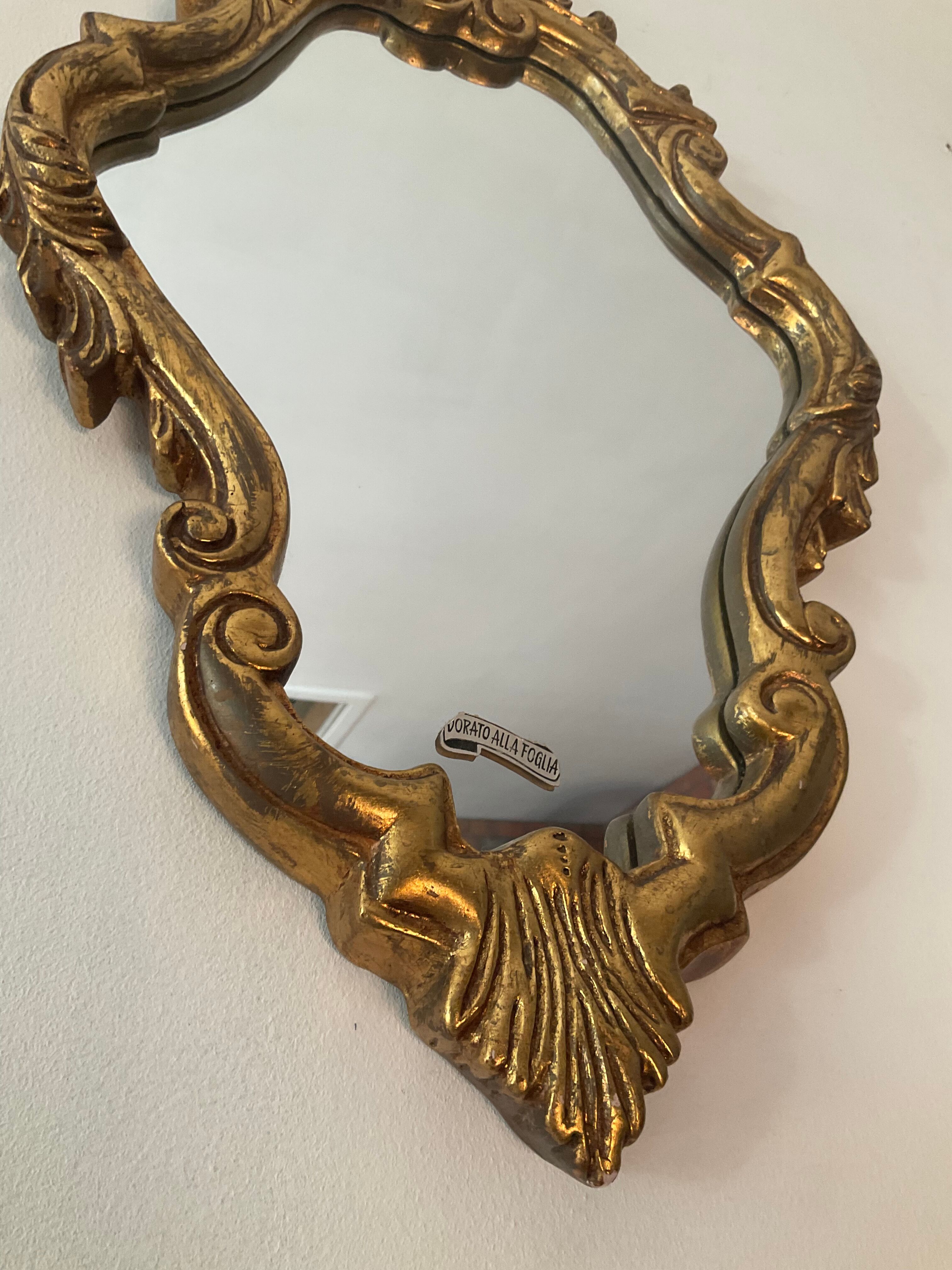 Old italian mirror in gilded plaster with leaf