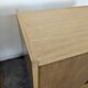 Pair of modernist sideboards with black glass doors in oak veneer.