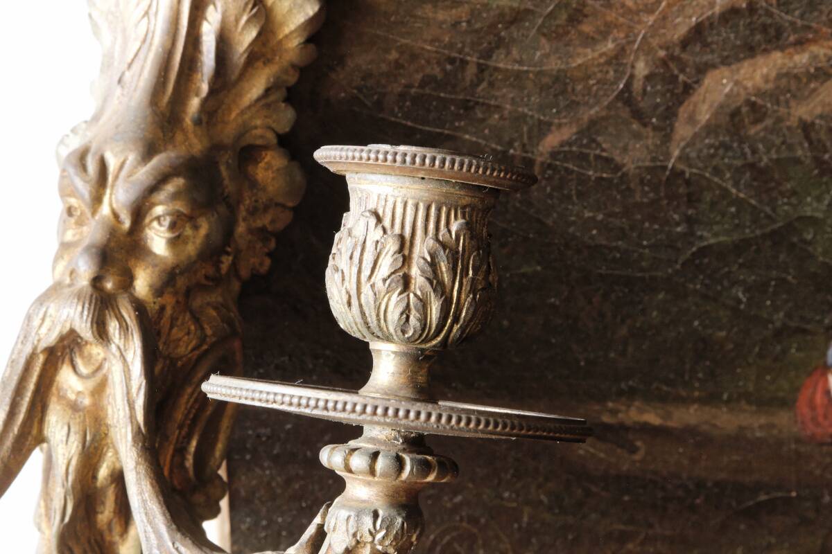 Monobloc gilded bronze wall light, grotesque satyr, two lights.
