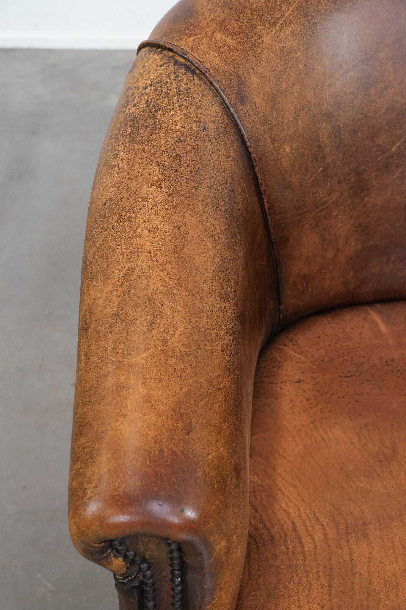 Vintage club chair in sheepskin leather with a characterful look