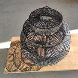 Braided rattan suspension in the shape of a black accordion