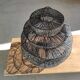 Braided rattan suspension in the shape of a black accordion