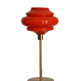 Table lamp with a vintage orange globe from an old pendant light