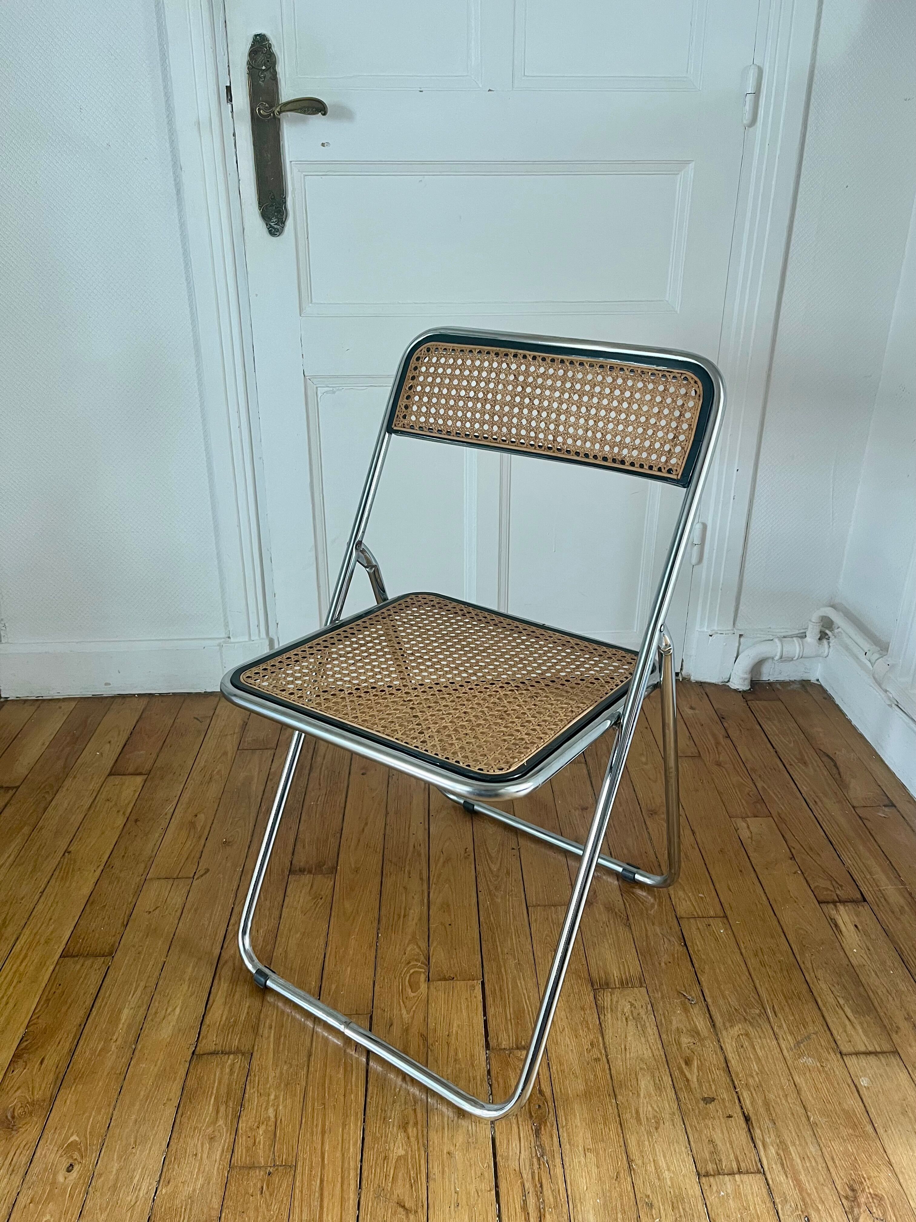 Vintage folding chair in metal and cane.