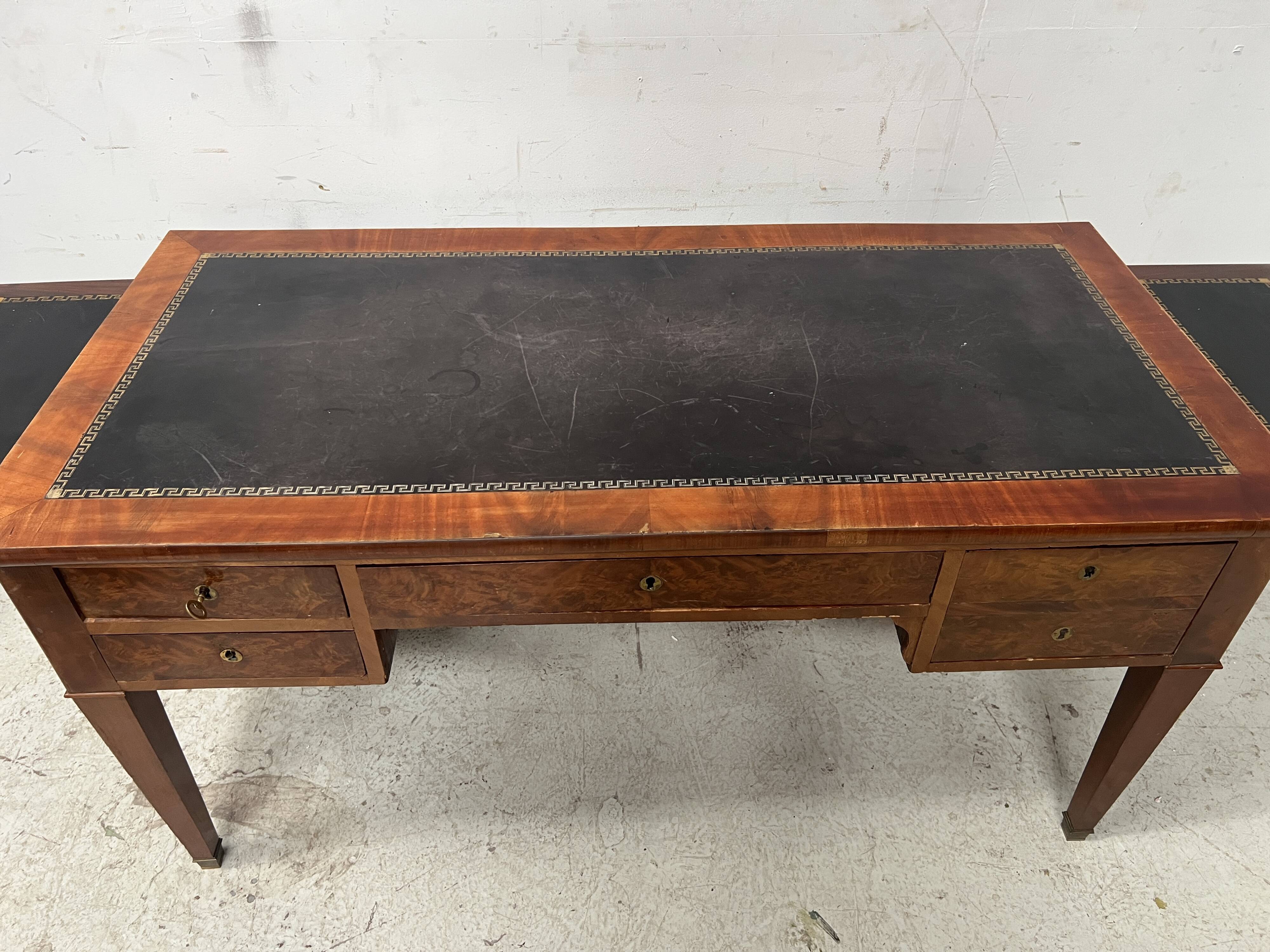 Louis XVI style flat desk in walnut and veneer, 19th century.