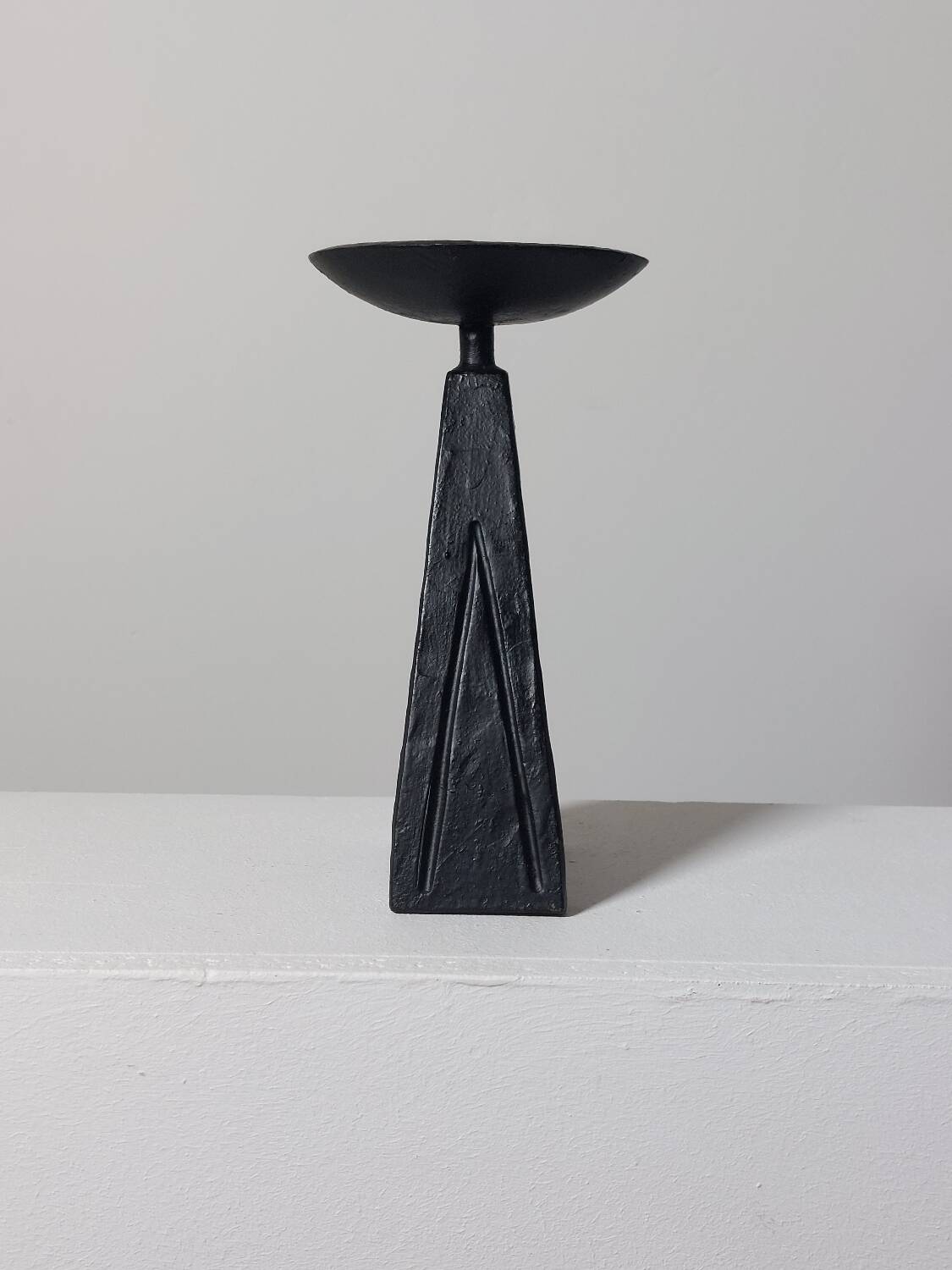 Vintage candle holder made of hand-forged metal, in a brutalist style.