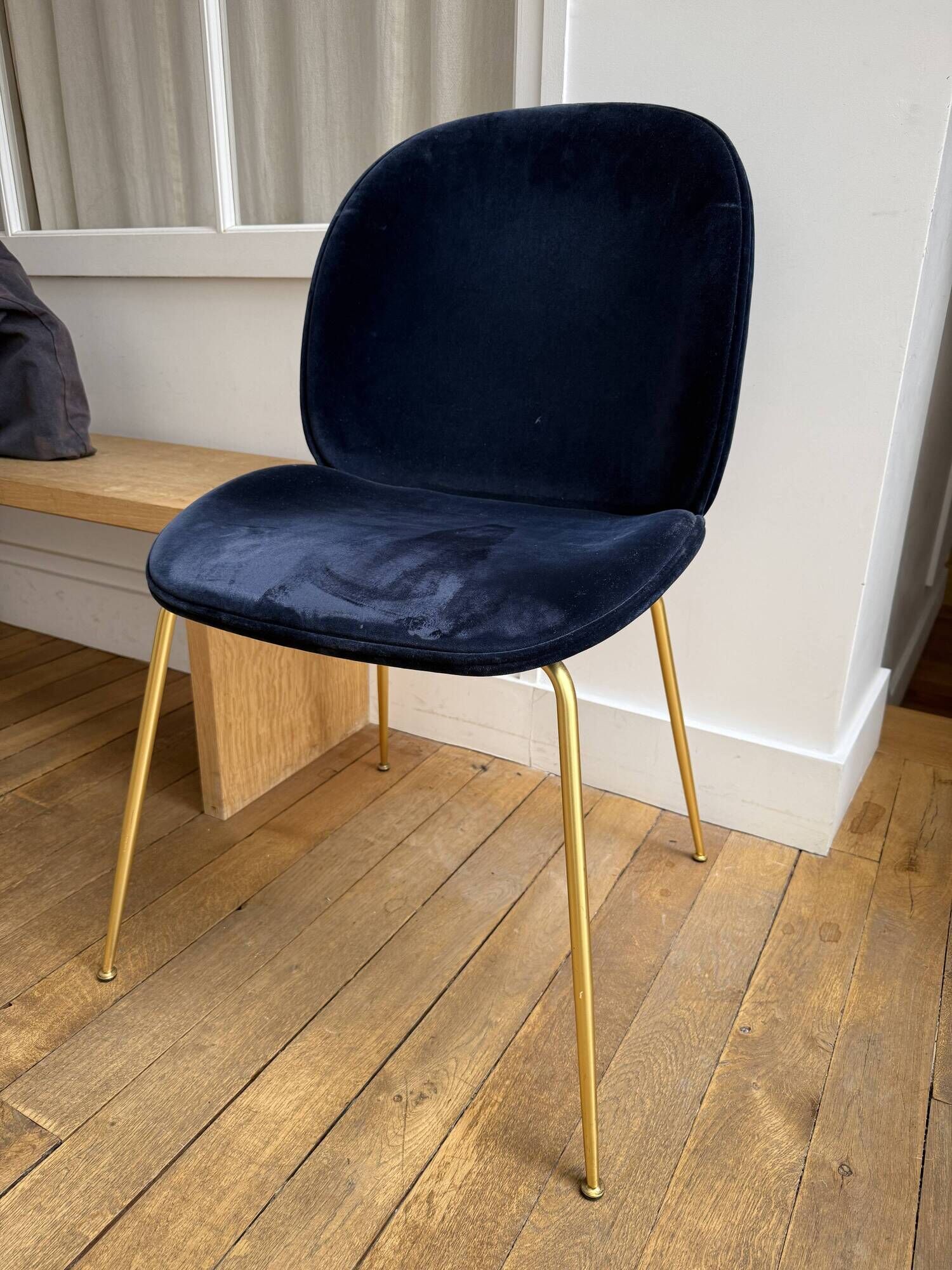 GUBI Beetle designer chair in midnight blue velvet with brass base
