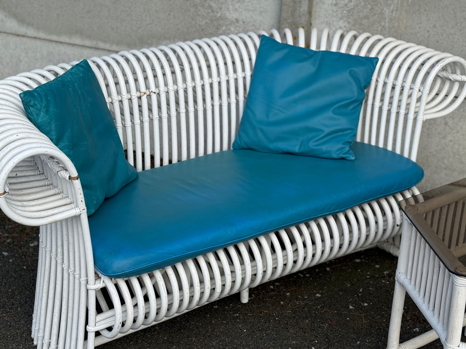 Rattan lounge with two two-seater sofas and a white coffee table.