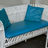 Rattan lounge with two two-seater sofas and a white coffee table.