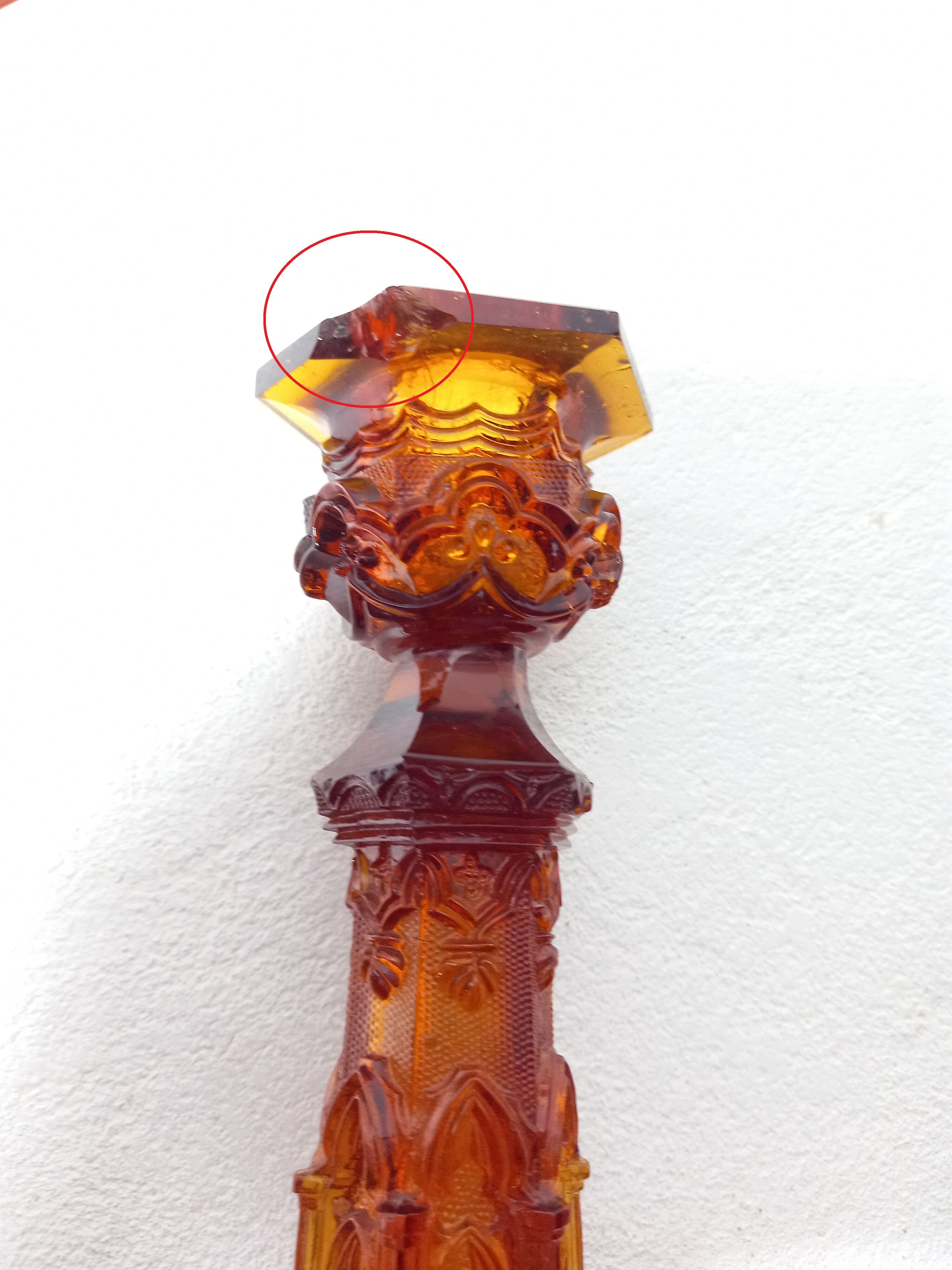 Pair of amber glass torches decorated with gothic motifs