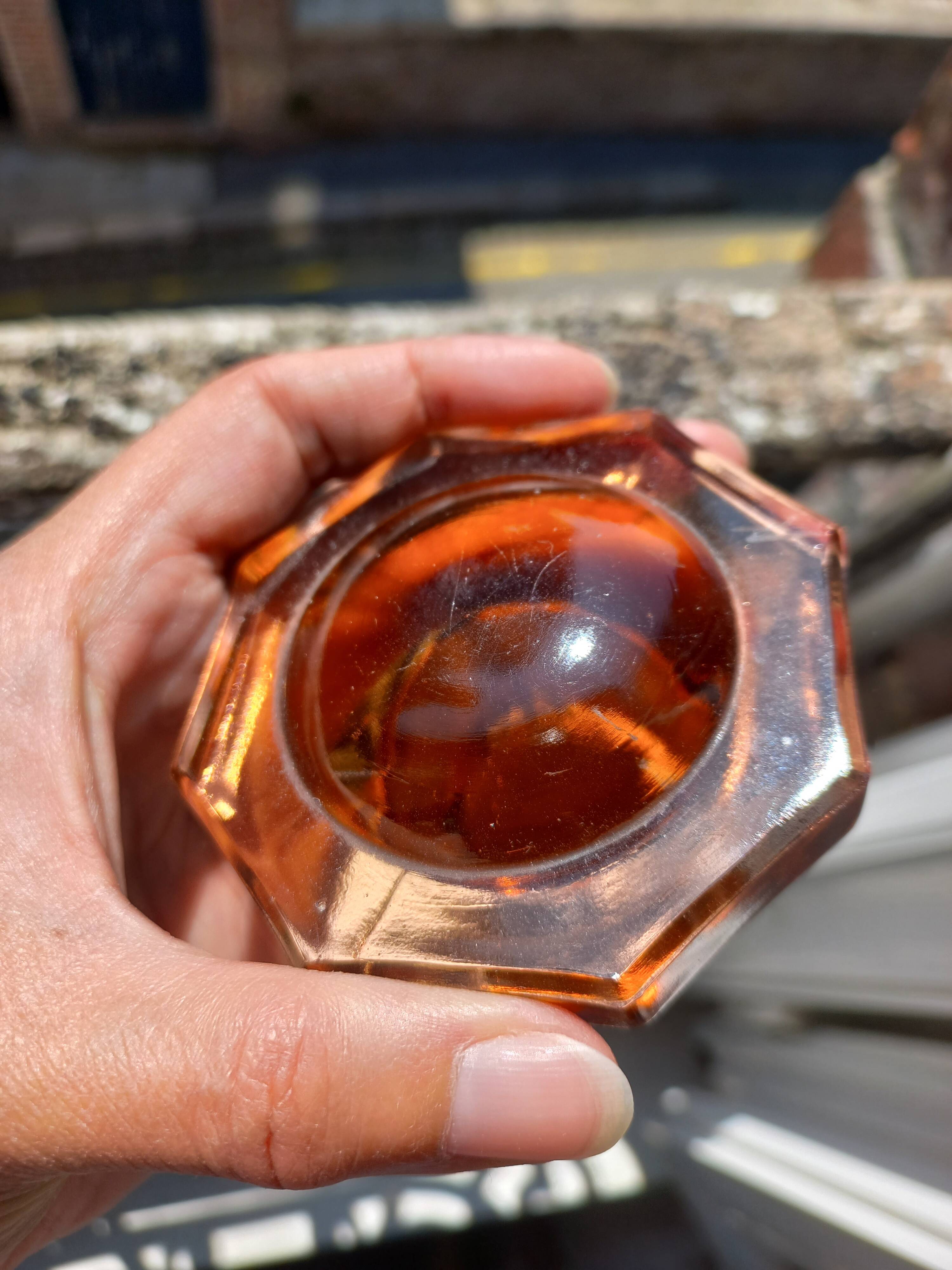 Vintage glass carafe in pink-orange, retro-chic style.