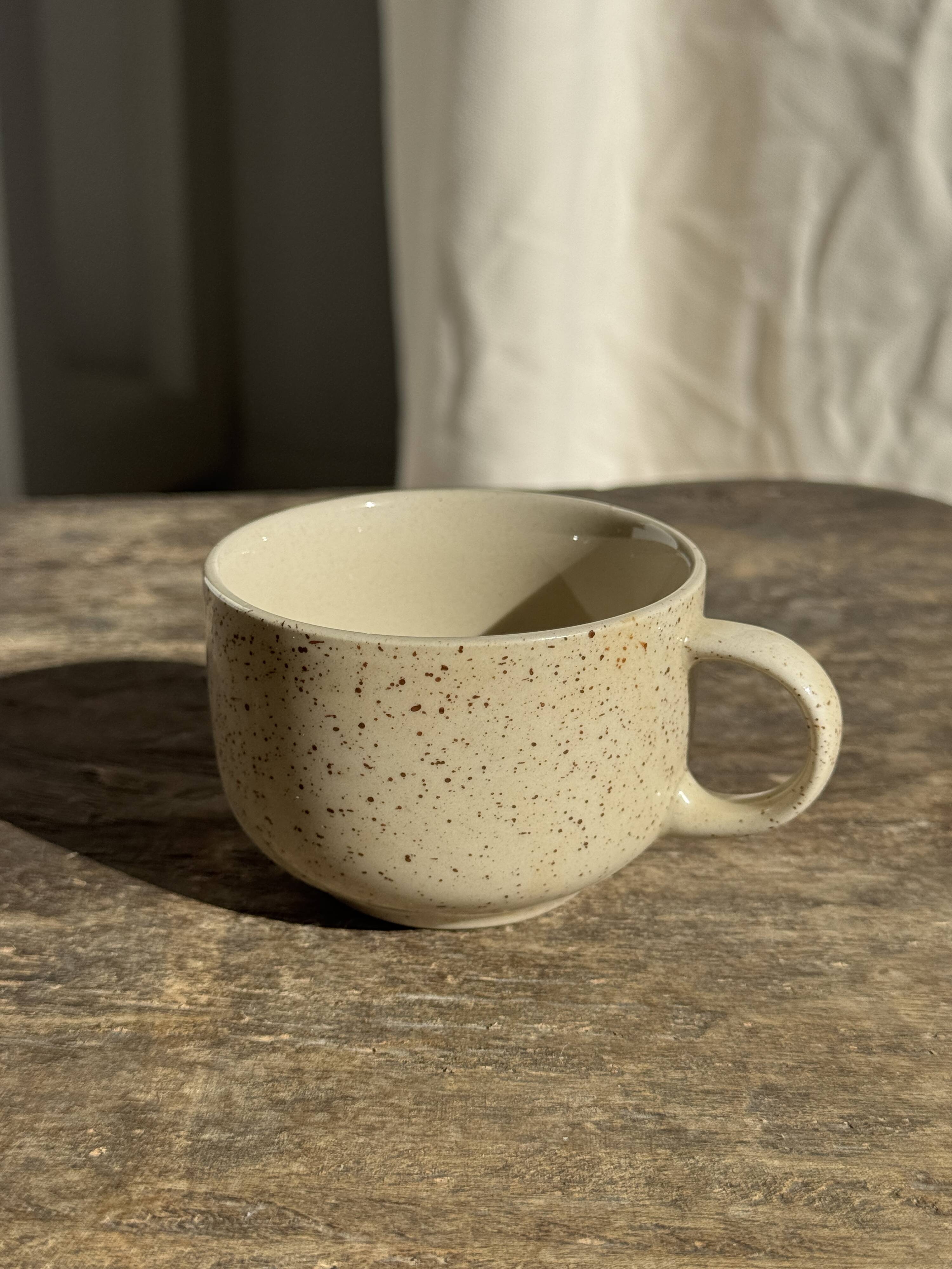 Set of 4 vintage speckled beige stoneware coffee cups.